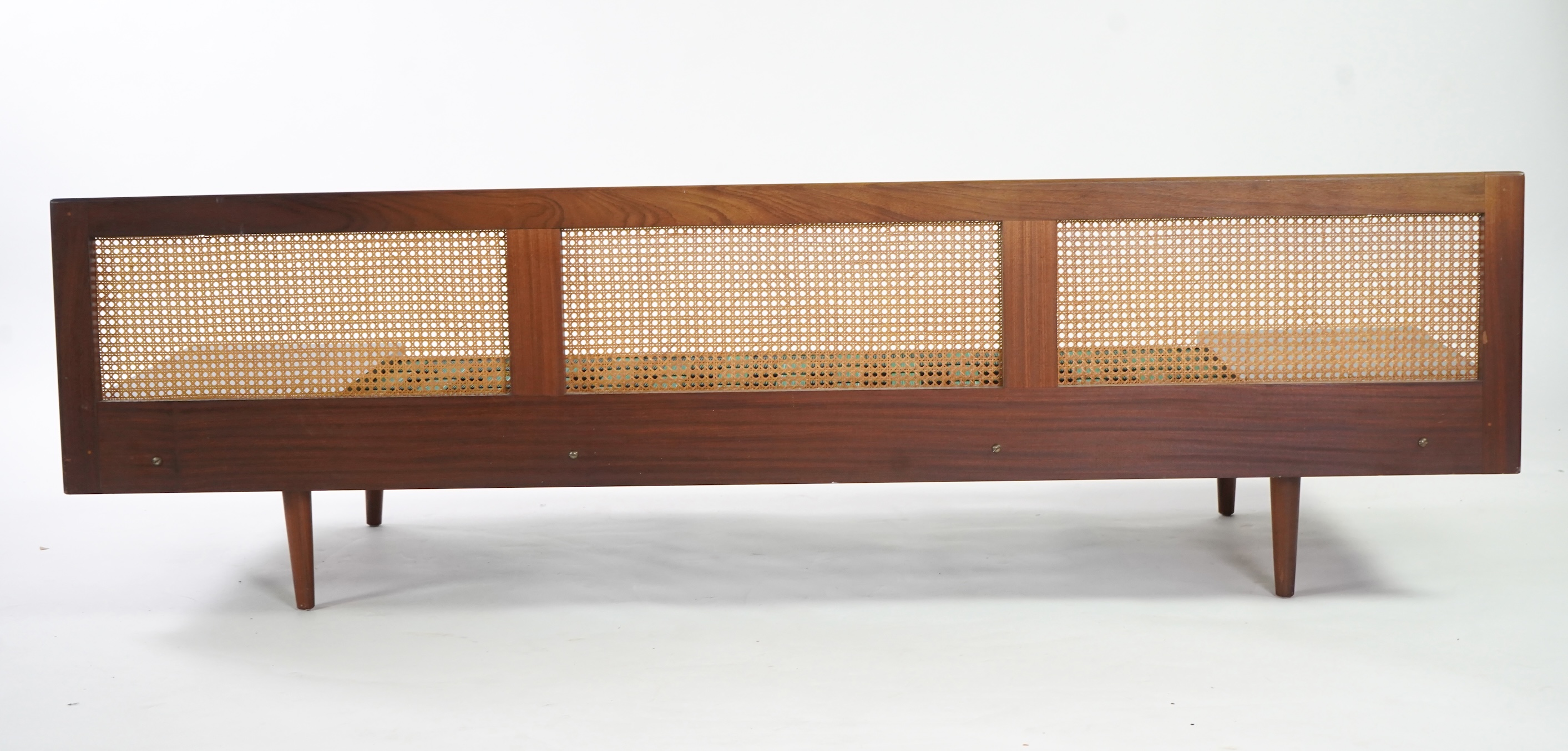 Dennis Young (British): A caned teak sofa/daybed